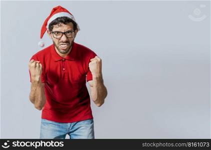 Man with beard and christmas hat angry looking at camera isolated. Furious christmas man looking at camera. People in christmas hats angry and furious looking at the camera.