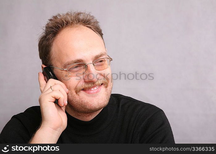 man with beard speaks on the cell phone