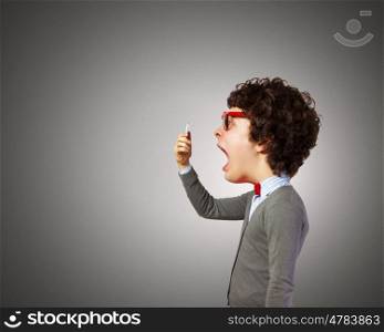 Man with big head. Funny young man with big head screaming emotional in mobile phone