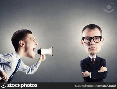 Man with big head. Funny young man with big head screaming emotionally in megaphone