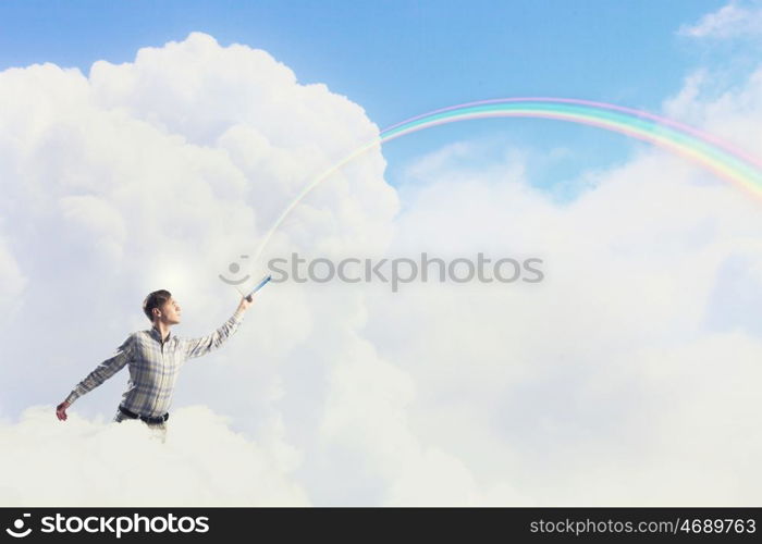 Man with book in hand. Young handsome man on sky background reaching hand with book