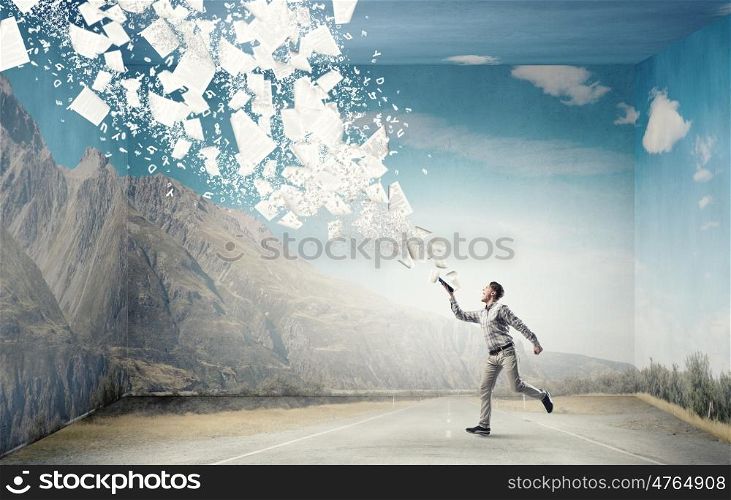 Man with book in hand. Young handsome man reaching hand with book