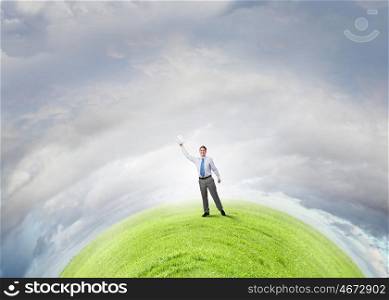 Man with book in hand. Young screaming businessman on hill reaching hand with opened book