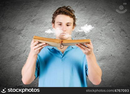 Man with book. Young man in casual holding opened book