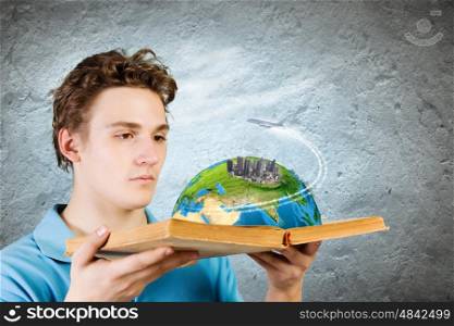 Man with book. Young man in casual holding opened book with city model. Elements of this image are furnished by NASA