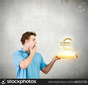 Man with book. Young man in casual holding opened book with euro sign