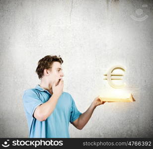 Man with book. young man in casual holding opened book with euro sign