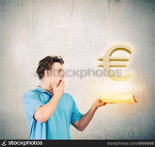 Man with book. Young man in casual holding opened book with euro sign