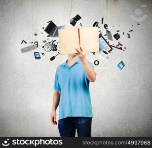 Man with book. Young man in casual holding opened book with icons flying out