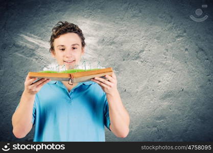 Man with book. Young man in casual holding opened book with windmills