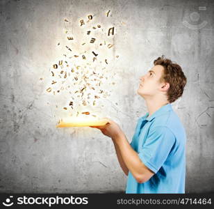 Man with book. Young man with opened book and characters flying out