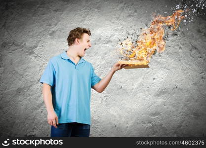 Man with book. Young man with opened burning book and characters flying out