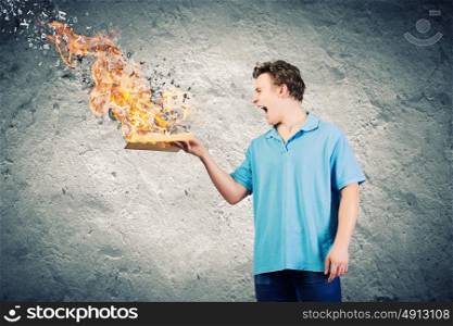 Man with book. Young man with opened burning book and characters flying out