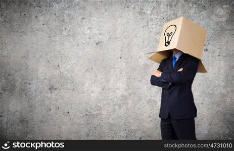 Man with box on head. Unrecognizable businessman wearing carton box on head