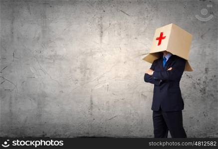 Man with box on head. Unrecognizable businessman wearing carton box on head