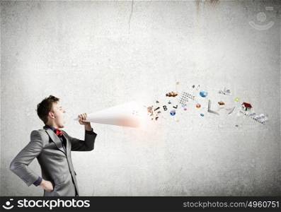 Man with bullhorn. Young businessman speaking in trumpet and colorful icons flying out