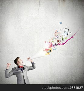 Man with bullhorn. Young businessman speaking in trumpet and colorful splashes flying out