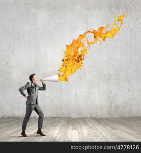 Man with bullhorn. Young businessman speaking in trumpet and colorful splashes flying out