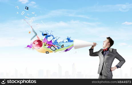 Man with bullhorn. Young businessman speaking in trumpet and colorful splashes flying out