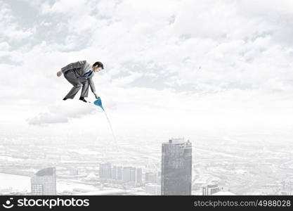 Man with can. Young businessman standing on cloud and watering something below