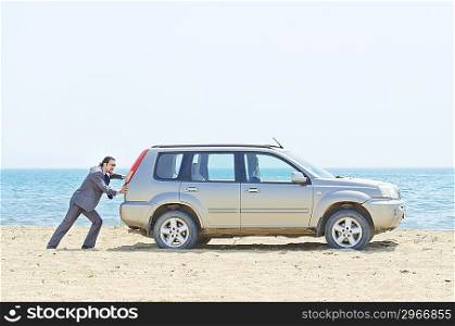 Man with car on seaside
