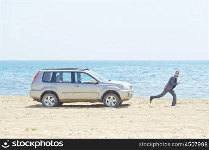 Man with car on seaside