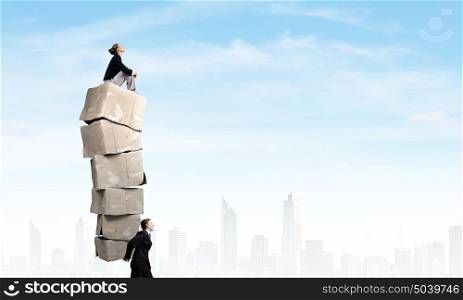 Man with carton boxes. Businessman carrying big stack of carton boxes