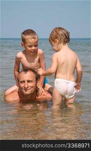 Man with children in sea