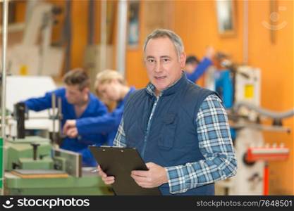 man with clipboard at a beer plant