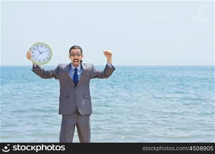 Man with clock on seaside