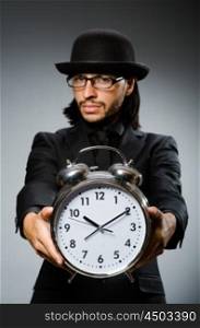 Man with clock wearing vintage hat