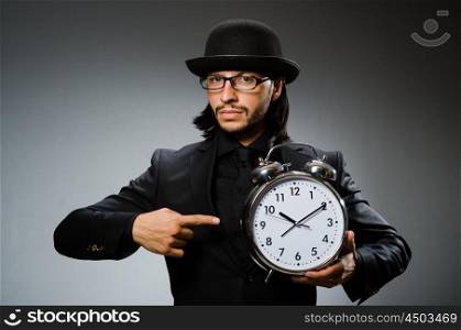 Man with clock wearing vintage hat
