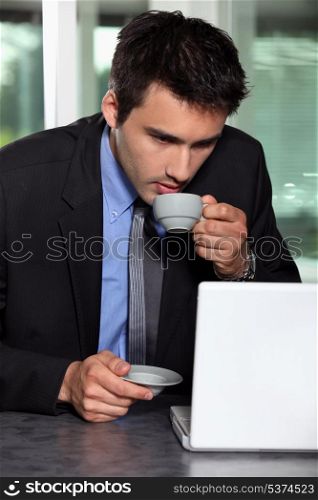 Man with computer and coffee cup