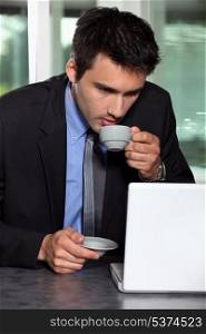 Man with computer and coffee cup