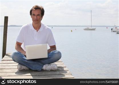Man with computer in dock