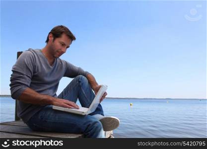 Man with computer in dock