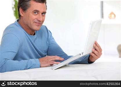 Man with computer inclined
