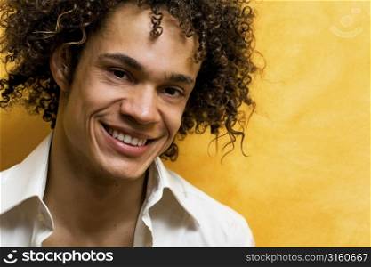 Man with curly hair on yellow