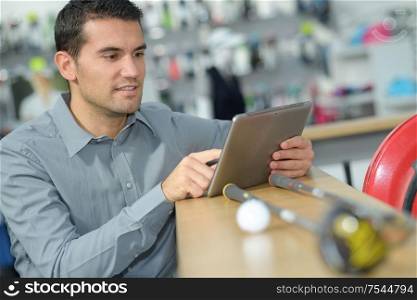 man with digital tablet in hardware store