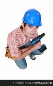 Man with drill kneeling