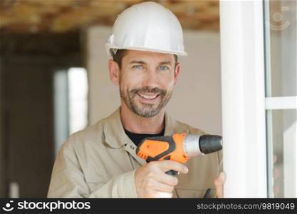 man with electric drill working at home closeup indoor shot