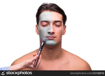 Man with face mask being applied on white