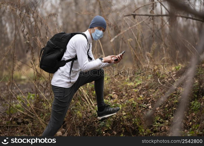 man with face mask woods