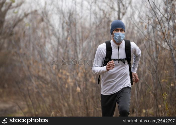 man with face mask woods running