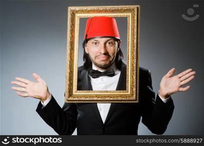 Man with fez hat and picture frame