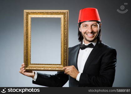 Man with fez hat and picture frame