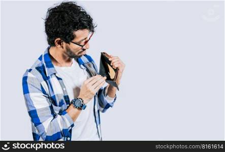 Man with financial problems showing empty wallet. Moneyless frustrated person concept. Sad man shaking an empty wallet, Sad person showing an empty wallet