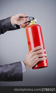 Man with fire extinguisher in firefighting concept