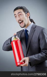 Man with fire extinguisher in firefighting concept