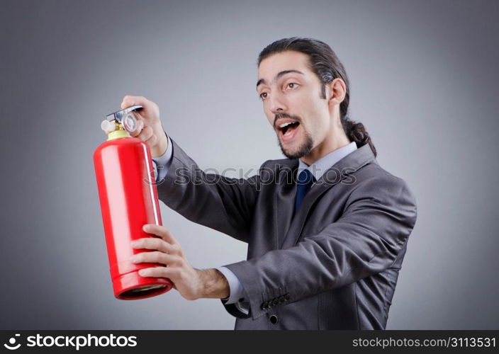 Man with fire extinguisher in firefighting concept